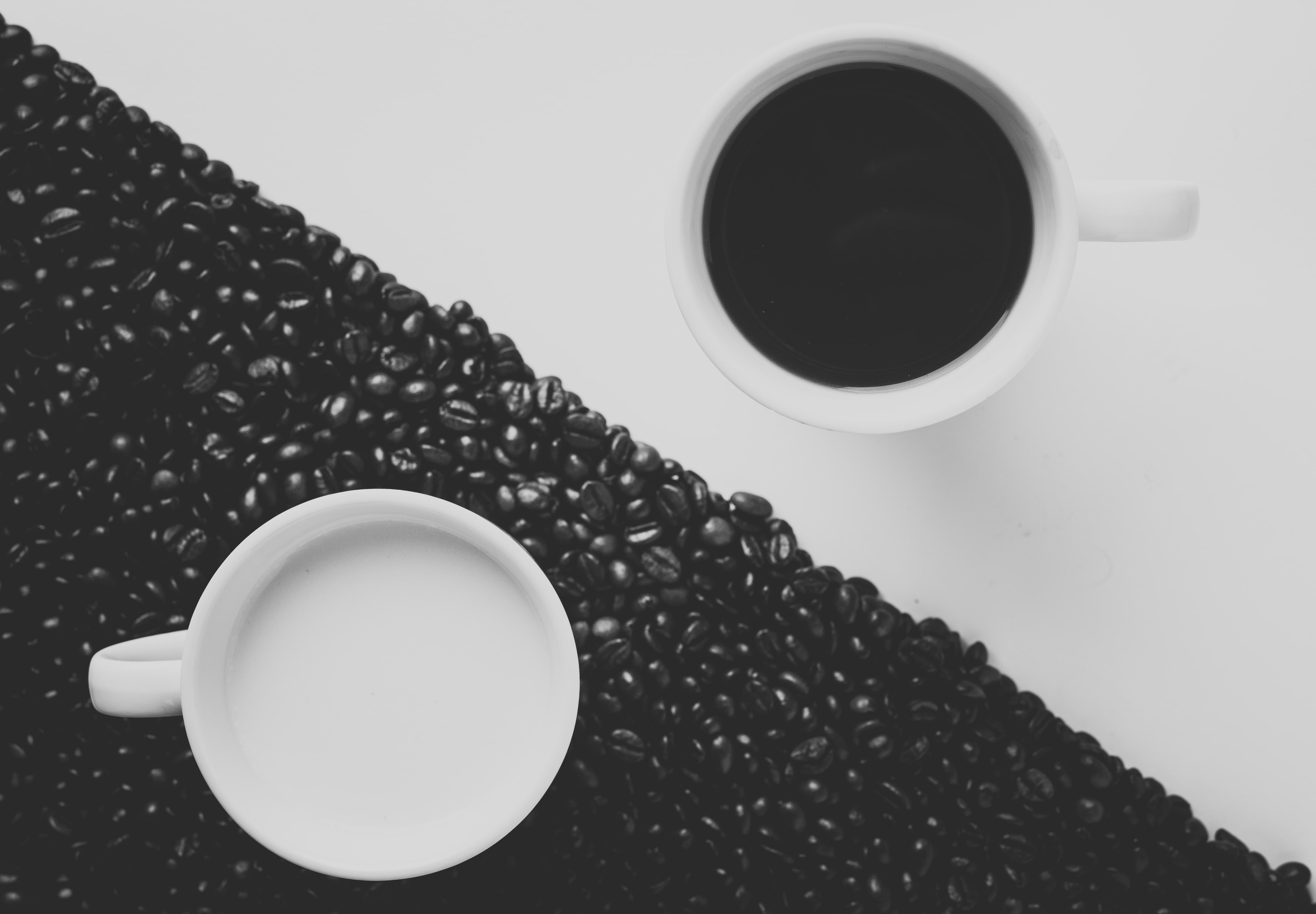 Yin-yang symbol formed with coffee cups and coffee beans.