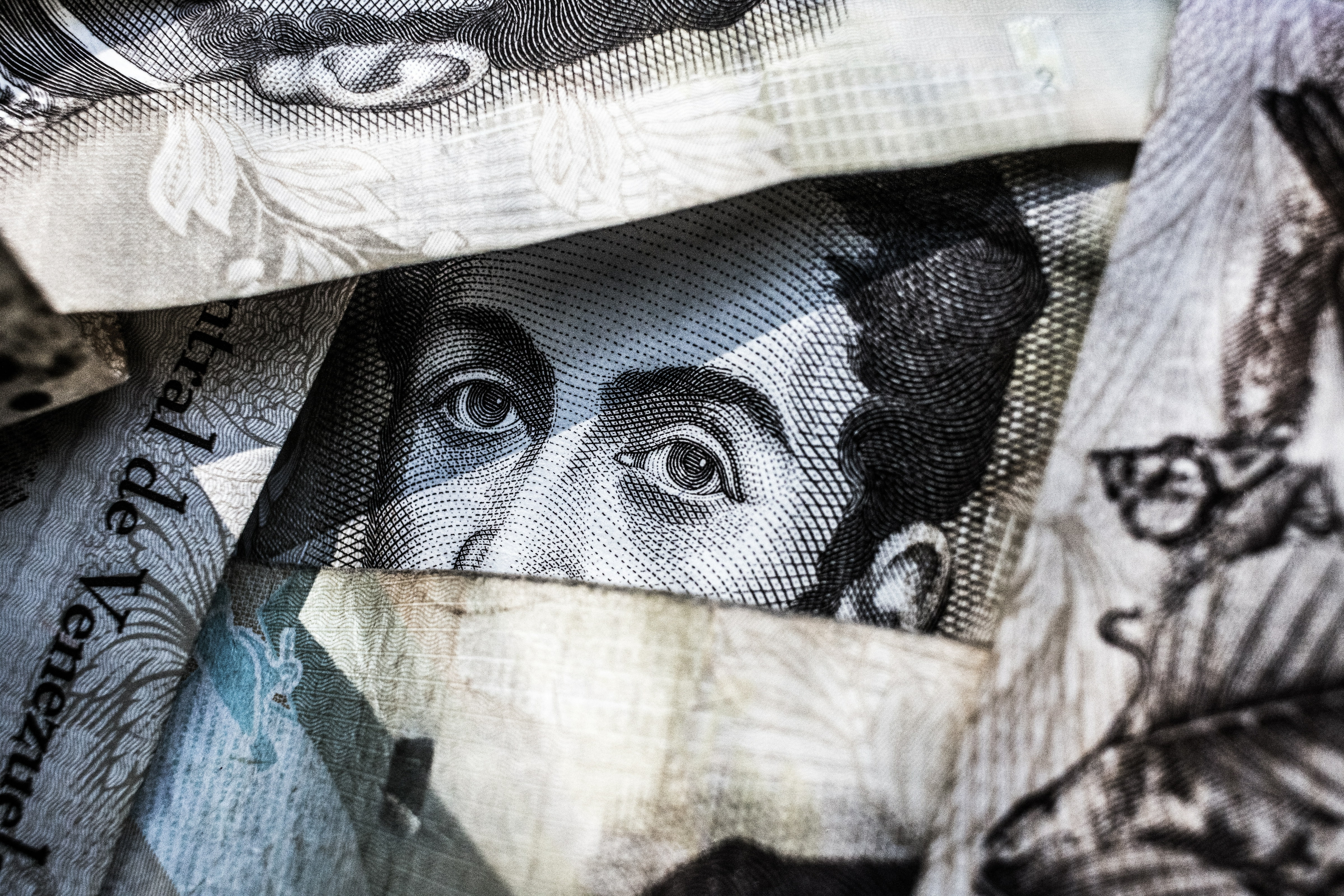 The eyes of Andrew Jackson peering through folded bills.