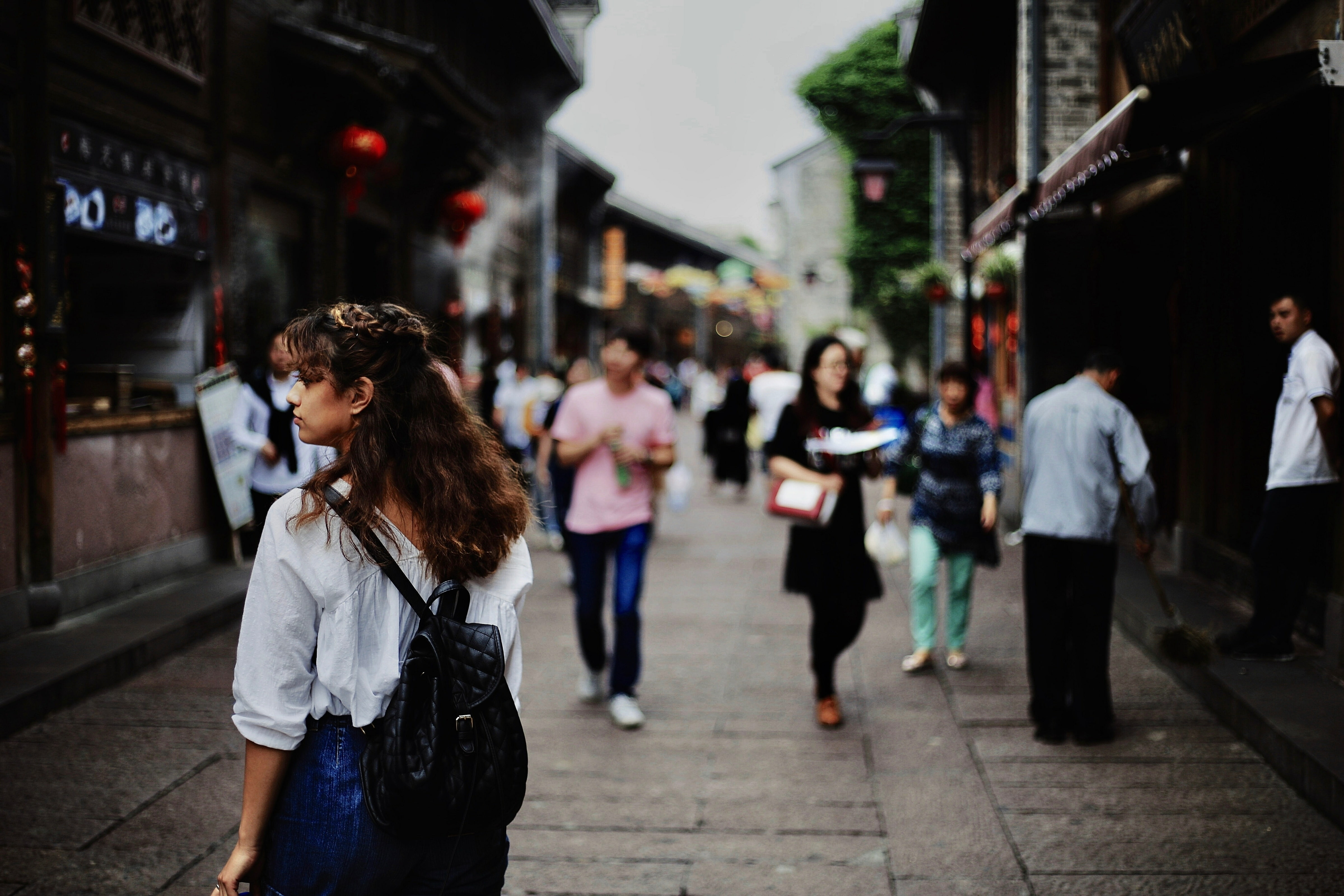 People walking in an outdoor market.