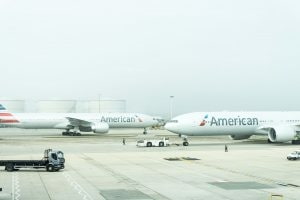 Two American Airlines planes sitting on the runway.