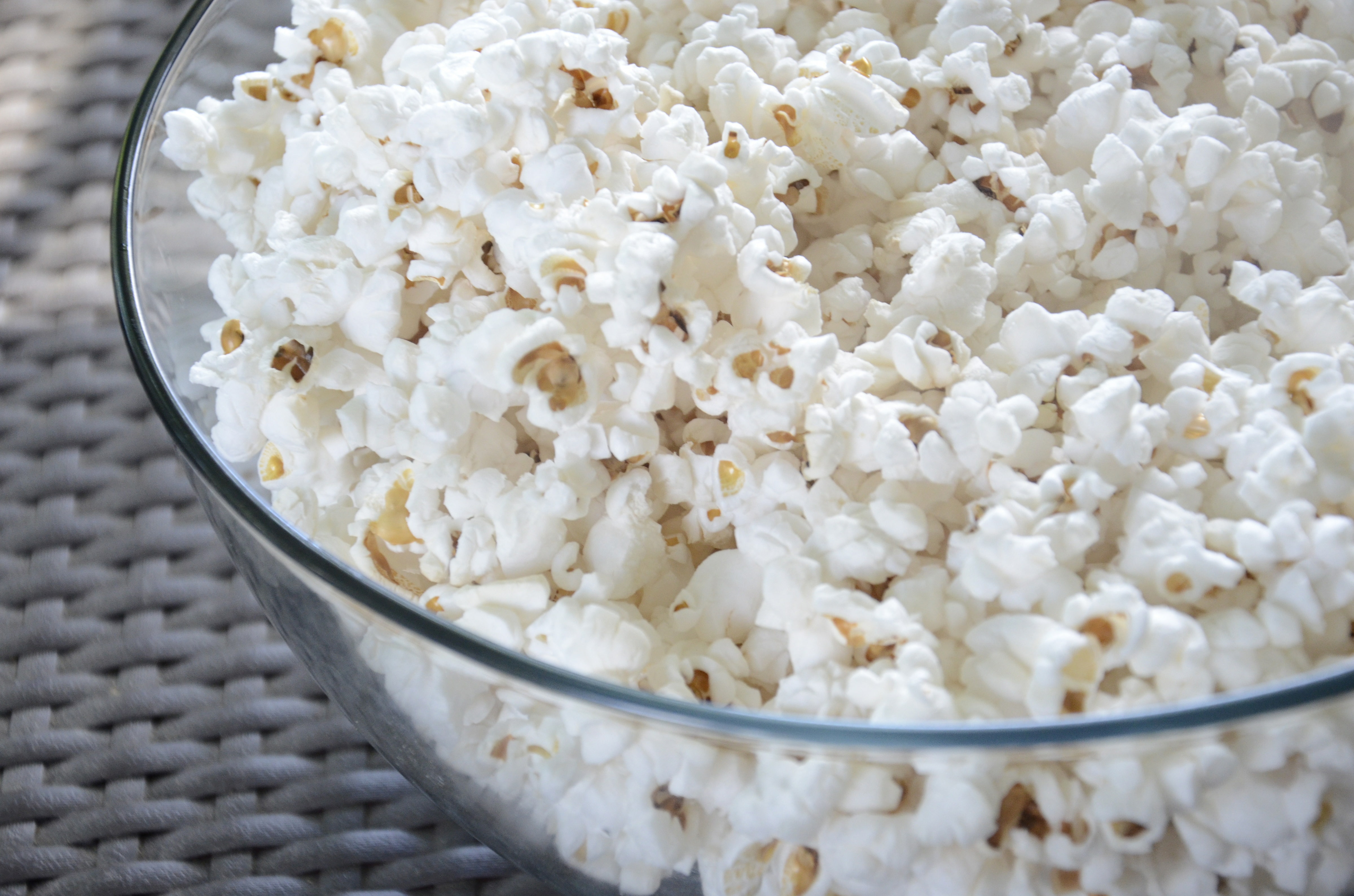 Popcorn in a clear glass bowl.