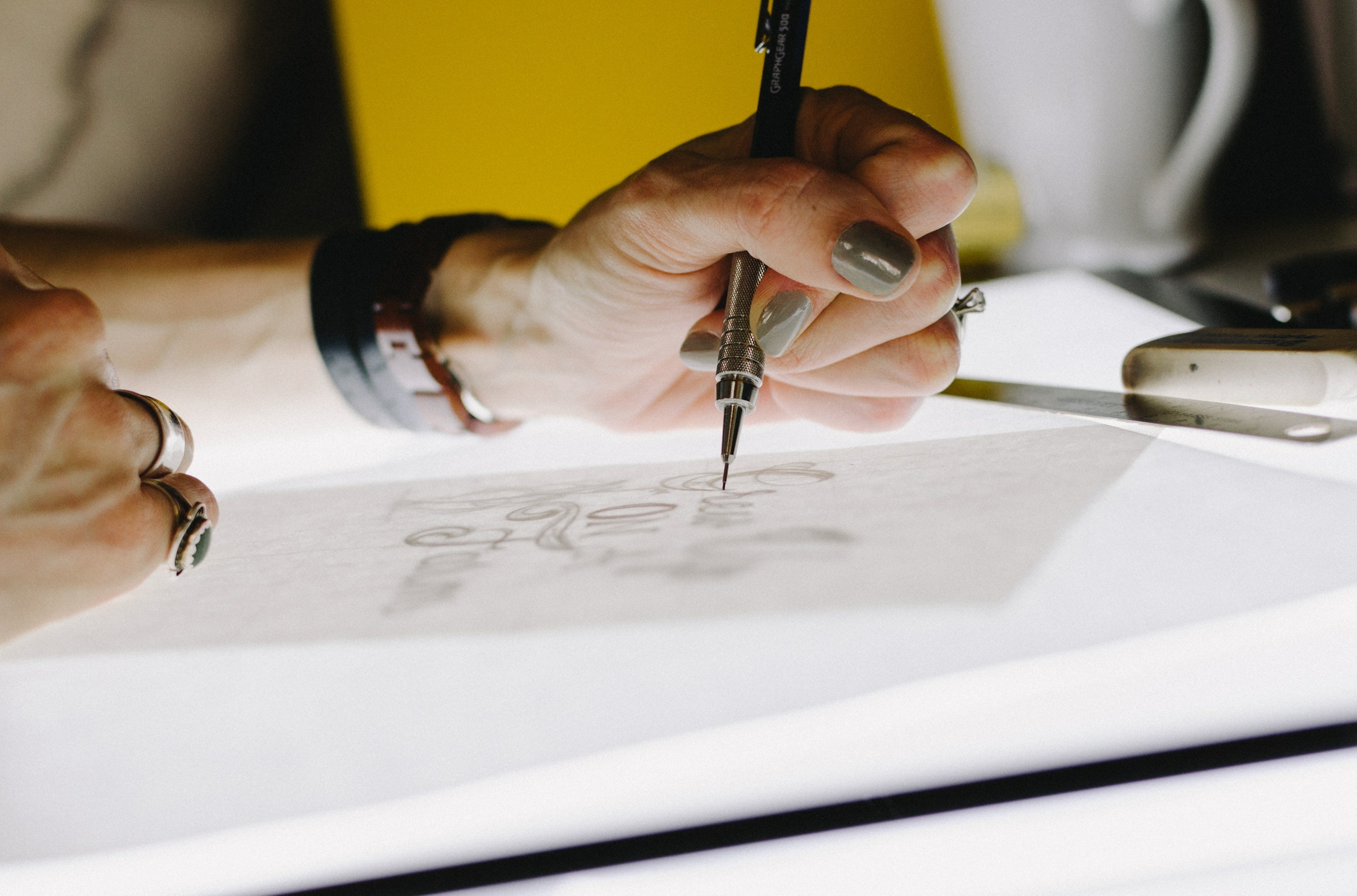 Graphic designer tracing typography.