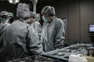 Male and female doctors in an operating room.