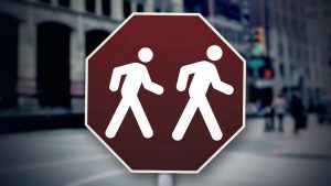 stop sign with two people walking
