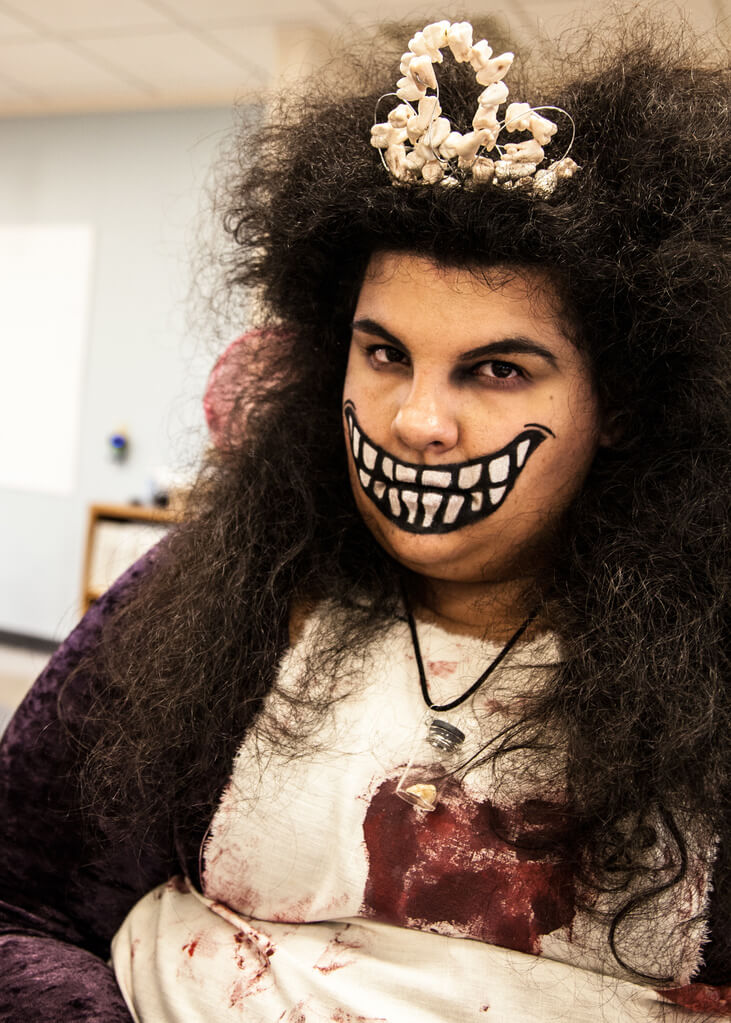 a woman wearing a scary toothfairy halloween costume