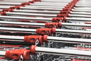 A row of quarter operated red shopping cart handles.