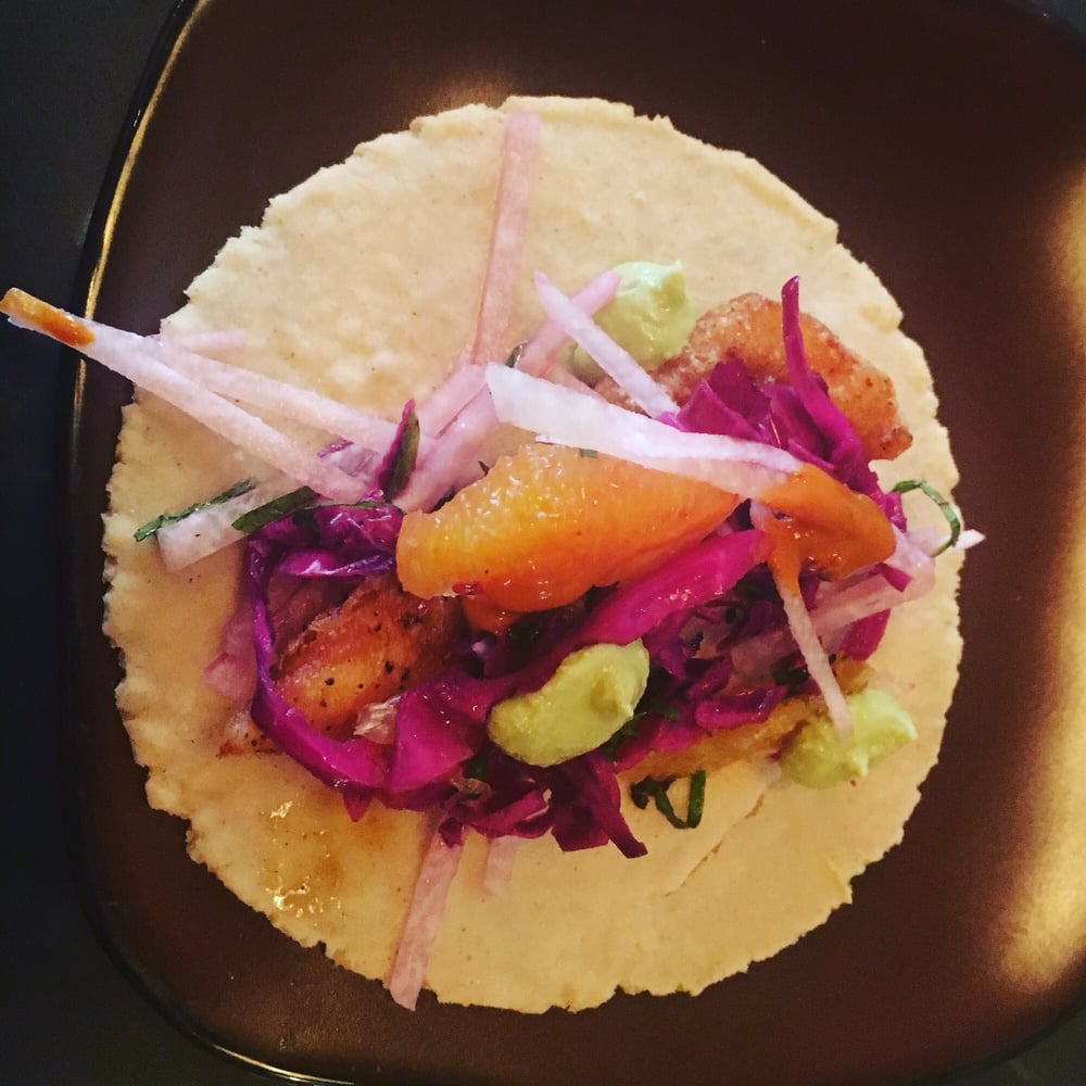 Very colorful taco ingredients on a handmade tortilla..