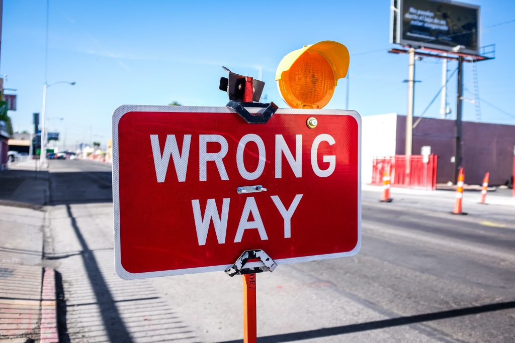 Street sign that says wrong way.