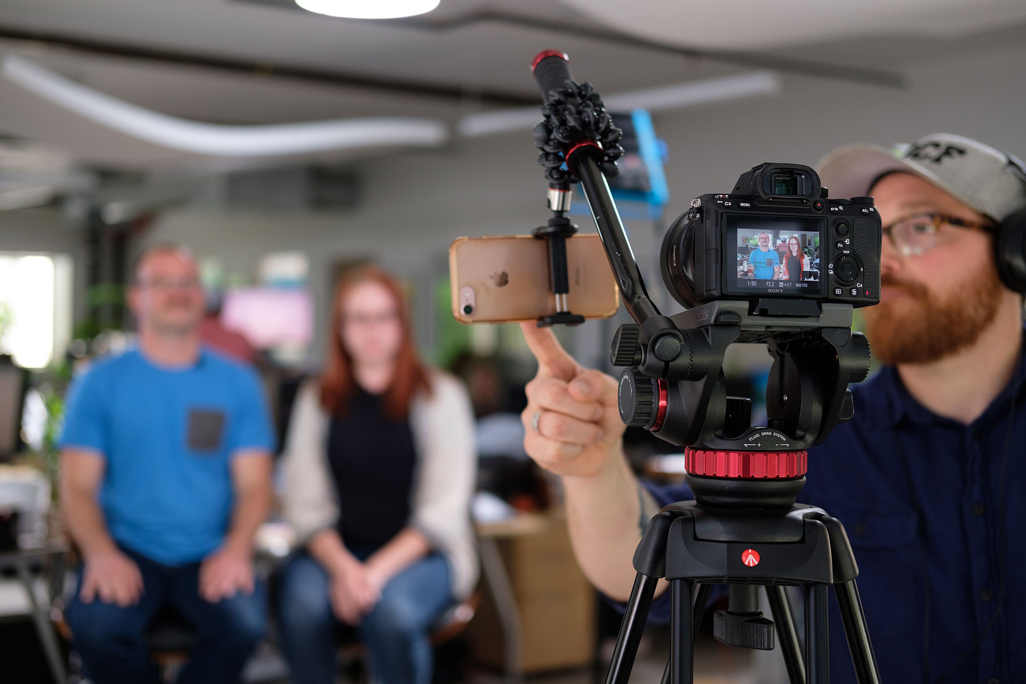 A videographer setting up camera equipment to film Monday Marketing Minute YouTube video.