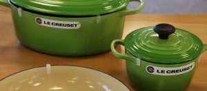 A new set of Le Creuset cookware on a table