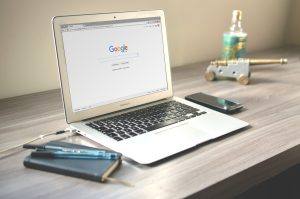 laptop on desk with google open on screen