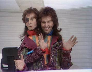 two men with mullets dressed in flashy clothes gesturing with their hands