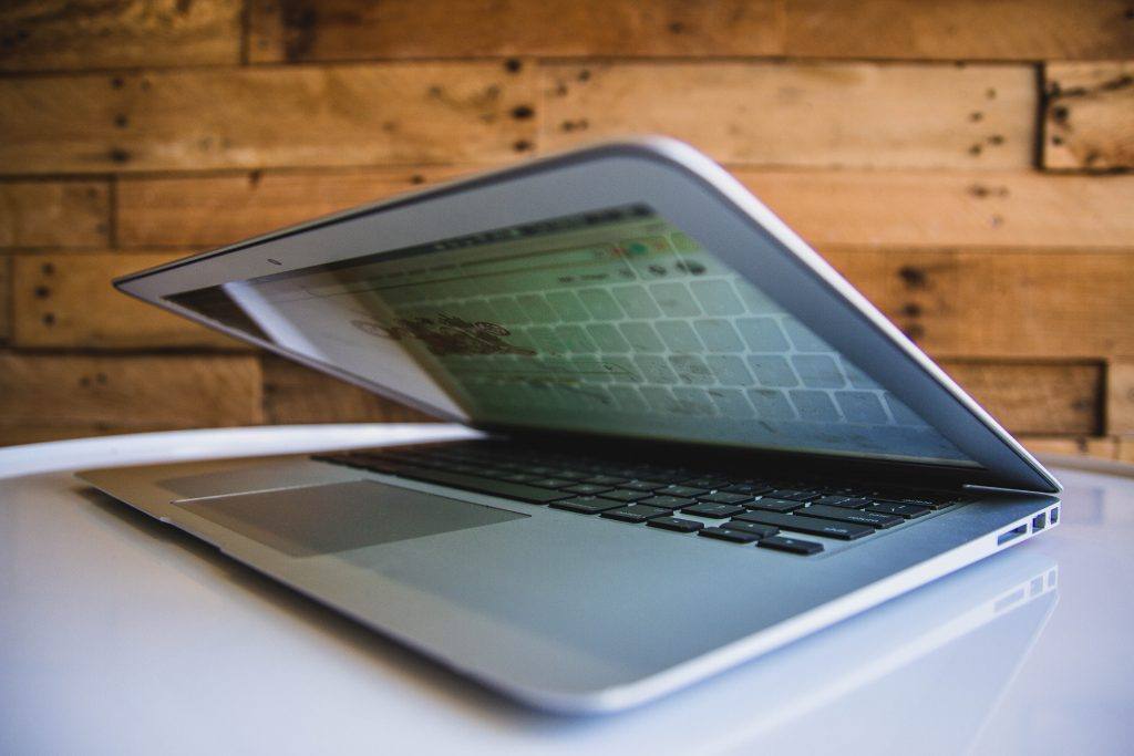 half closed laptop with screen display on