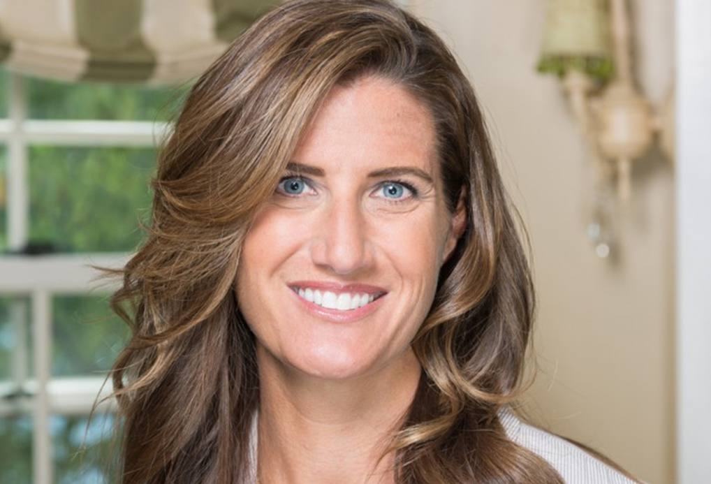 smiling woman with curling brown hair