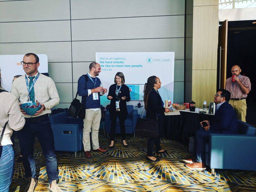 people dressed in professional attire at a conference booth