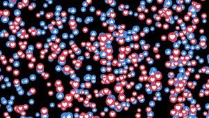 Red heart and blue thumbs-up emojis on a screen