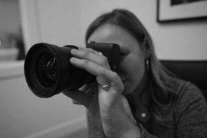 Video marketing expert adjusts her camera lens