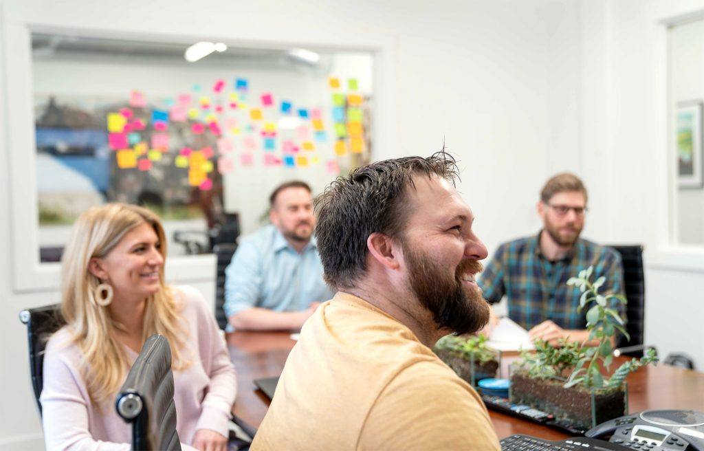 oneupweb digital marketing team smiling, planning, and strategizing