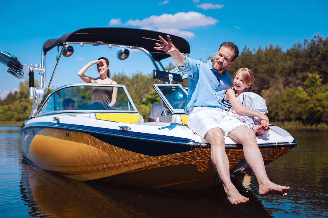 a young man, his wife, and his daughter boating on a lake