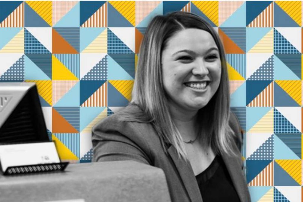 An Honor Bank employee smiling in front of geometric background