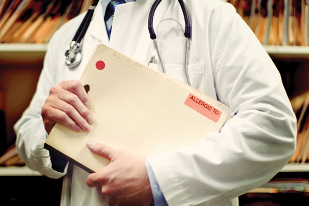 Doctor holds folder and wears stethescope