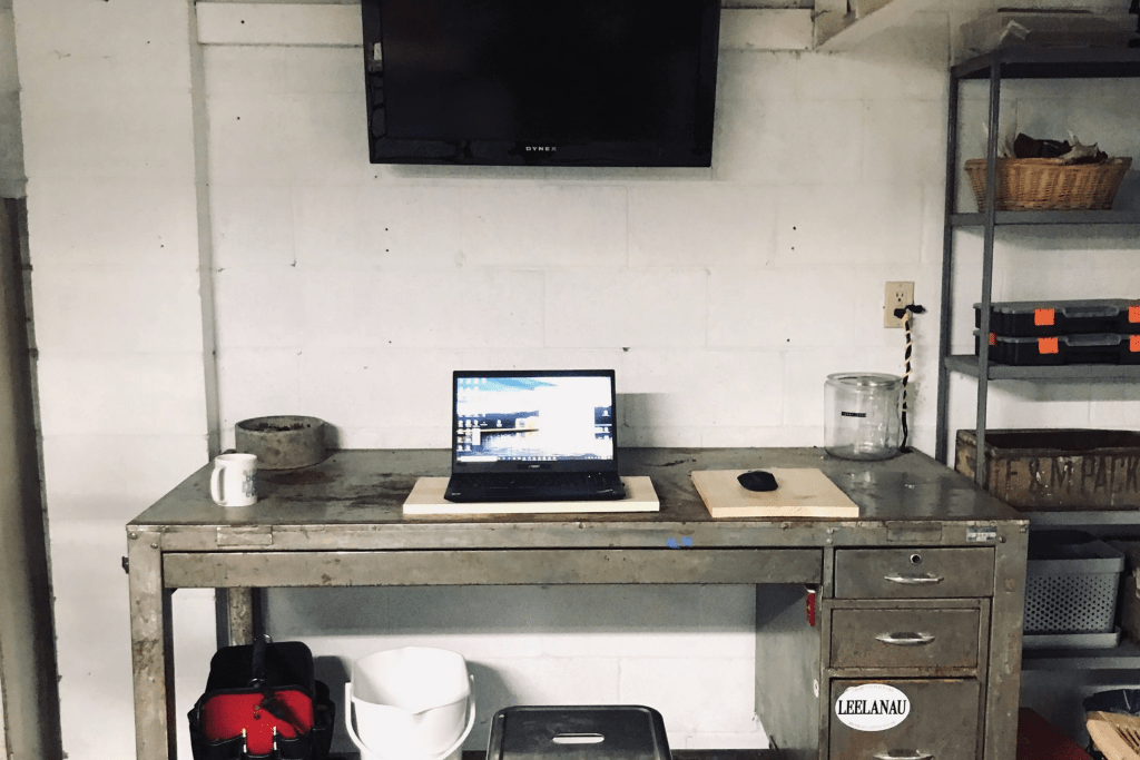 Employees remote office which is a desk in a garage