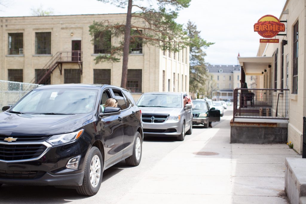 Line of cars waiting to pick up food while working remotely