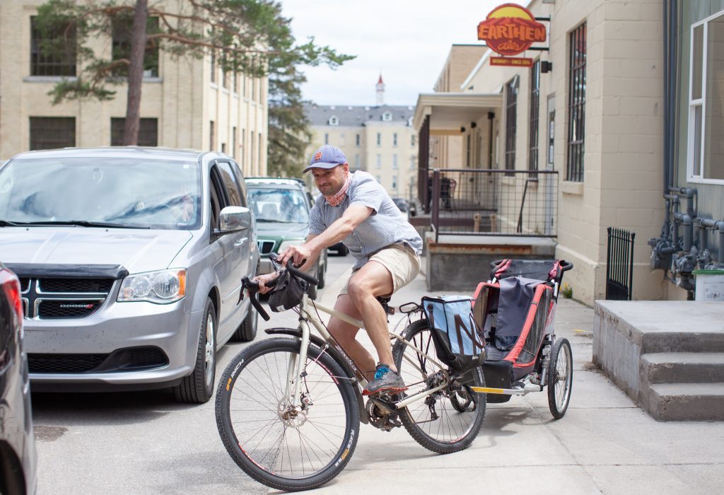 Man riding bike to pick up food while working remotely