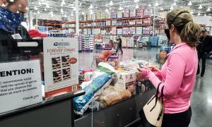 Millennial wearing face mask grocery shopping during pandemic