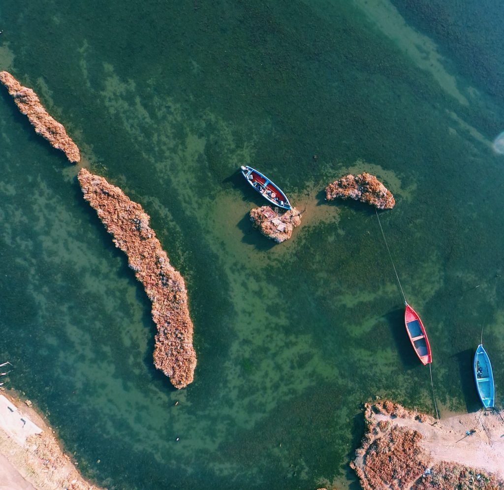 Overhead view of small islands with row boats tied to them