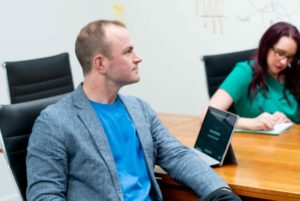 team of marketers in a meeting room offering consulting to a client