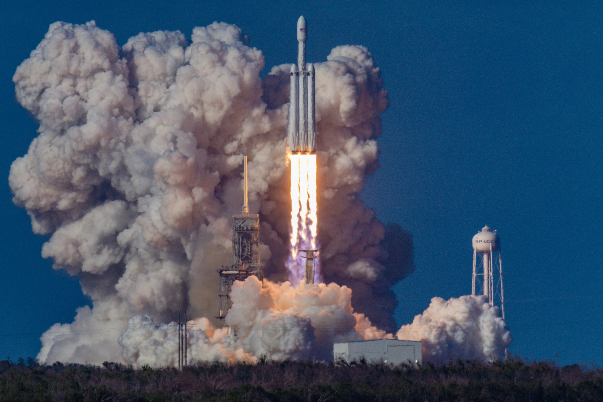 wide shot of rocket taking off from landing strip with fire coming from the turbos