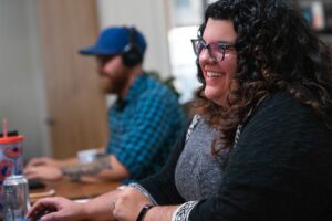 a marketer works at her computer and smiles