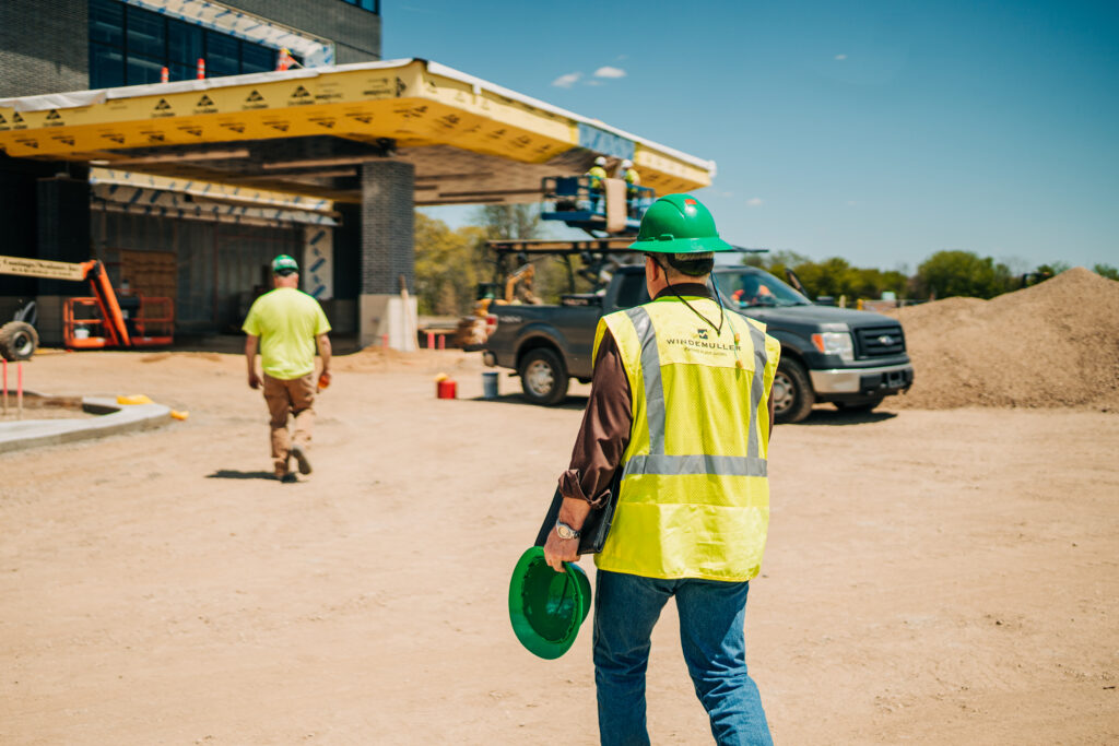 construction workers walk back to the job site