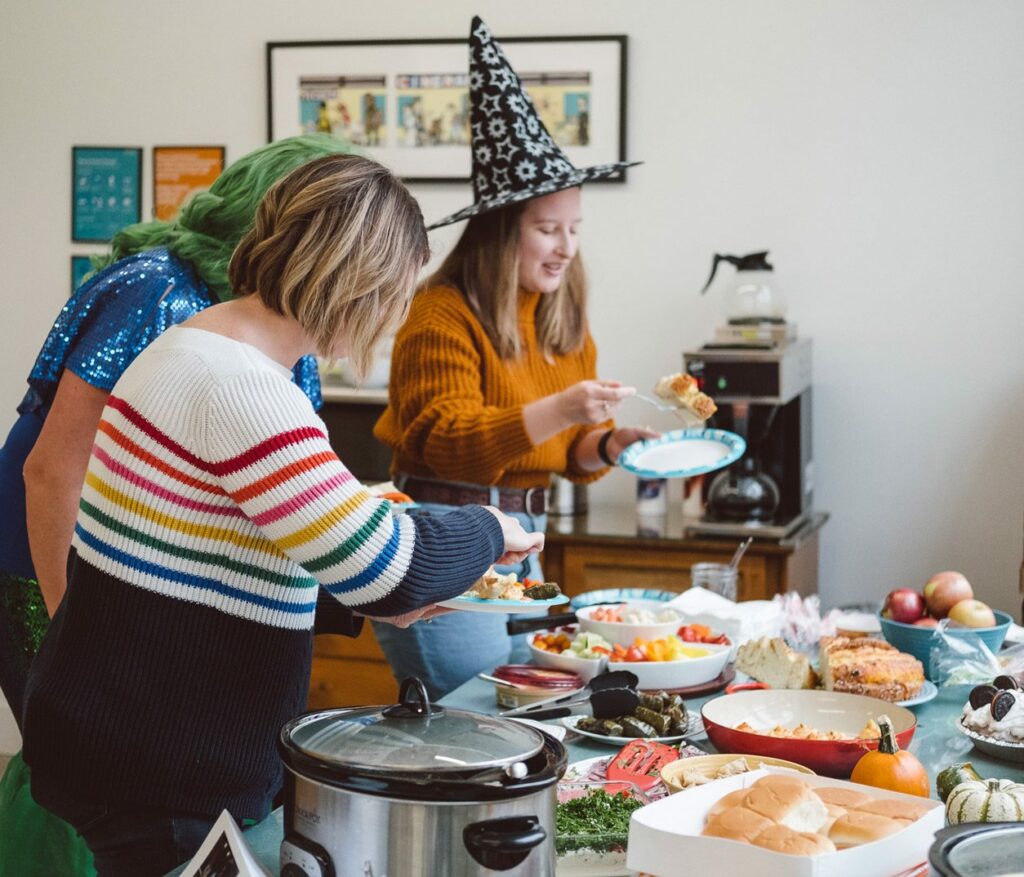 Oneupweb employees dressed up and setting up the Halloween potluck.