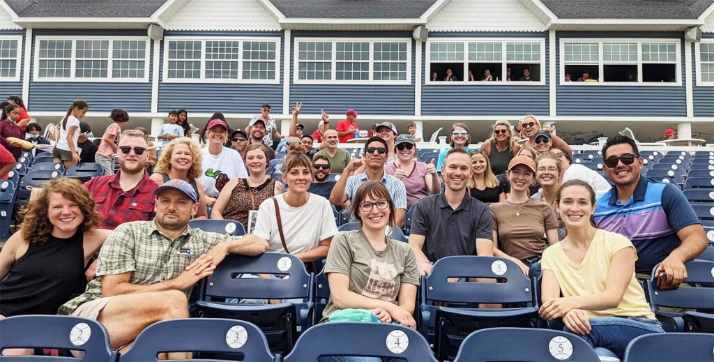Oneupweb employees at a baseball game.