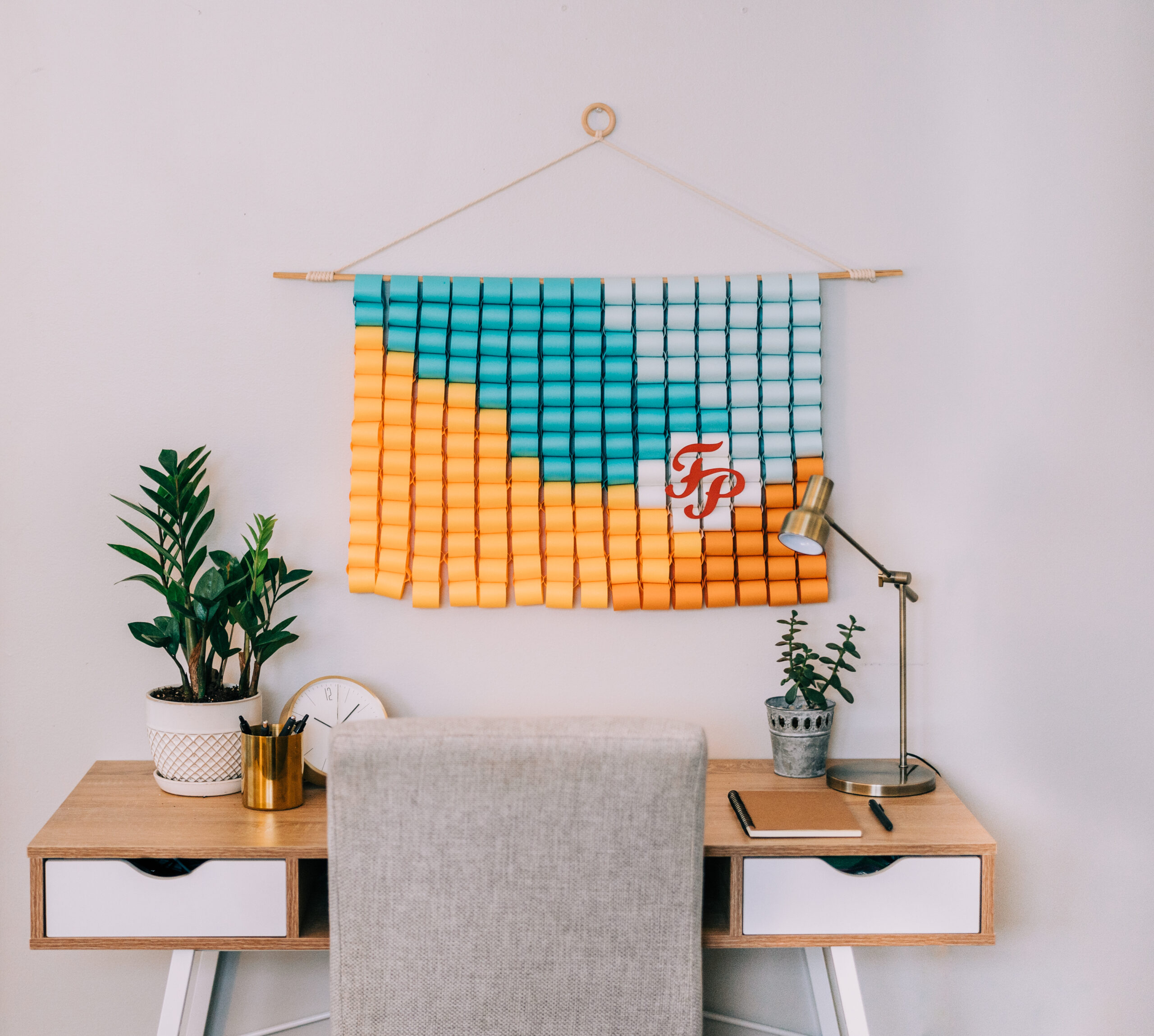 a modern office desk with a beautiful designed post it note macrame hanger