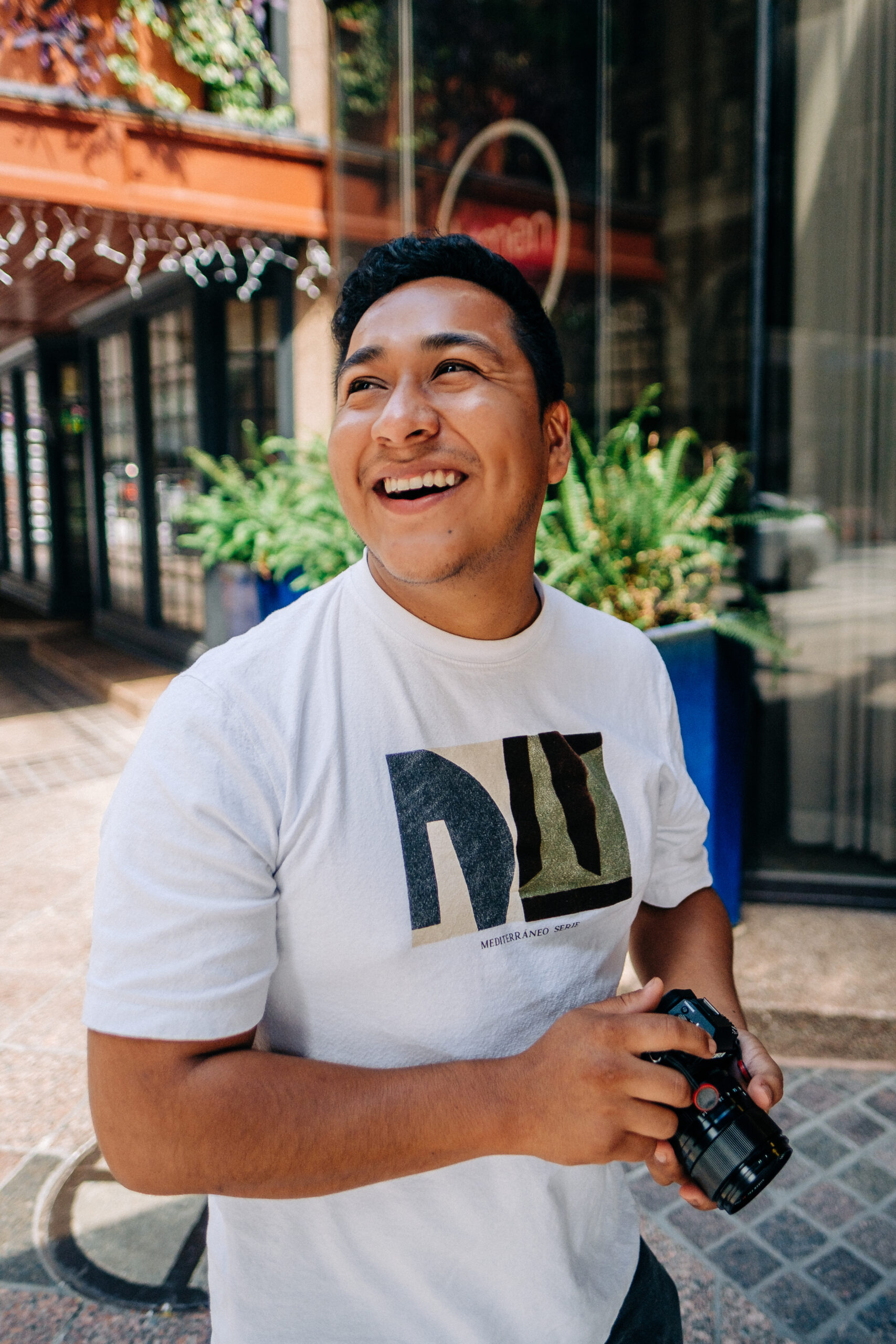 rafael quiroz smiling with a camera in hand