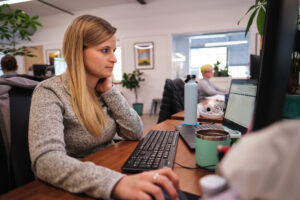 a female marketer works at her computer optimizing content