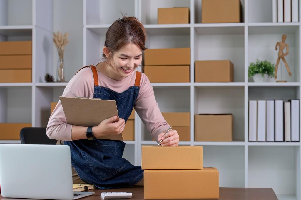 A young woman eagerly completes an ecommerce order.