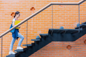 University student walk climb stairs step up in school campus to rise higher success smart woman concept.