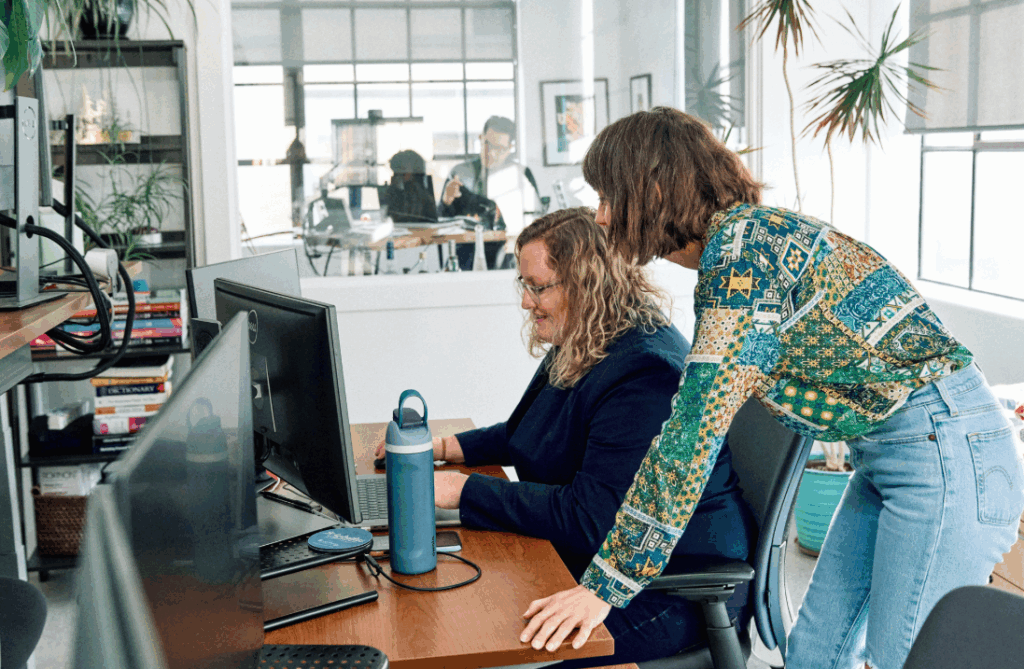 Marketers review client performance in an open office space.